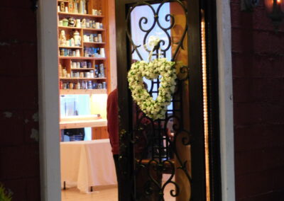 a heart shaped flower wreath on a door